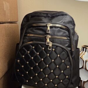 Elegant Black Quilted Backpack with Gold Details